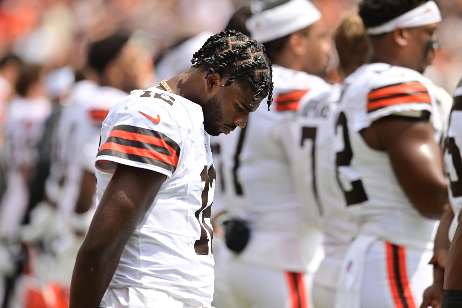 Cleveland Browns quarterback Shedeur Sanders (12) listens to the national anthem before the game between the Browns and the Los Angeles Rams at Huntington Bank Field.