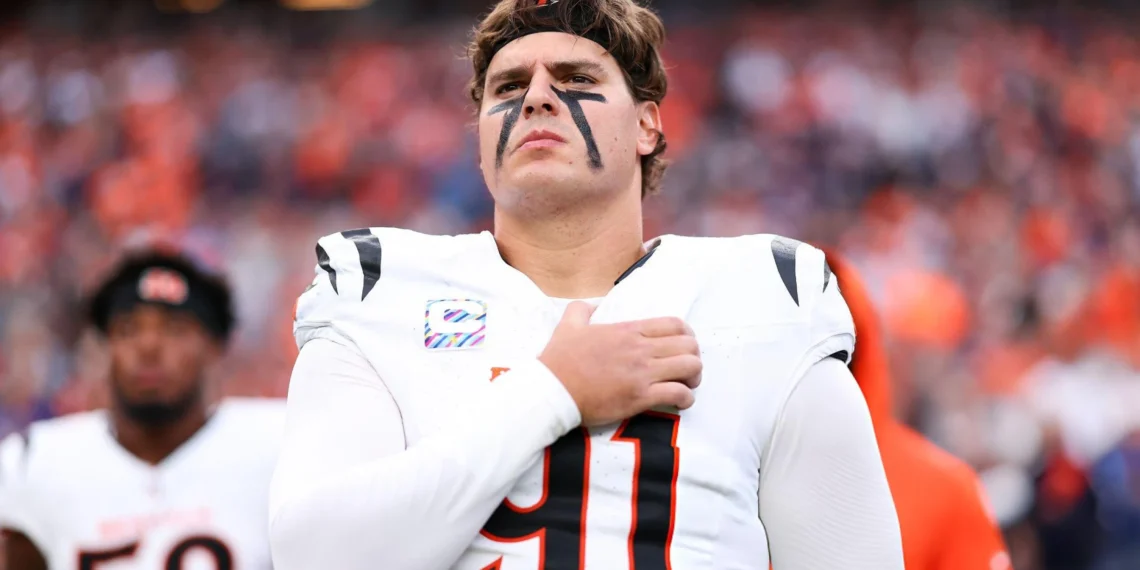 Trey Hendrickson #91 of the Cincinnati Bengals stands on the sideline during the national anthem prior to the game against the Denver Broncos at Empower Field at Mile High in Denver, Colorado.