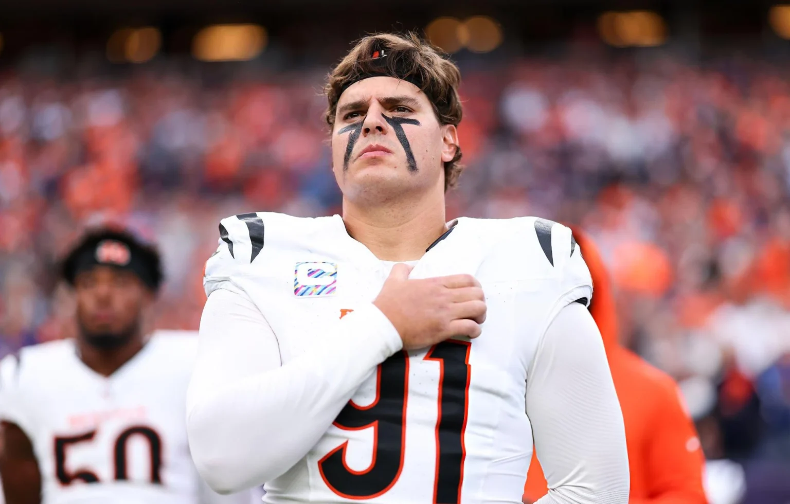 Coach Zac Taylor Sounds Off on Trey Hendrickson’s Injury Update as Bengals Prepare for Jets Trey Hendrickson #91 of the Cincinnati Bengals stands on the sideline during the national anthem prior to the game against the Denver Broncos at Empower Field at Mile High in Denver, Colorado.