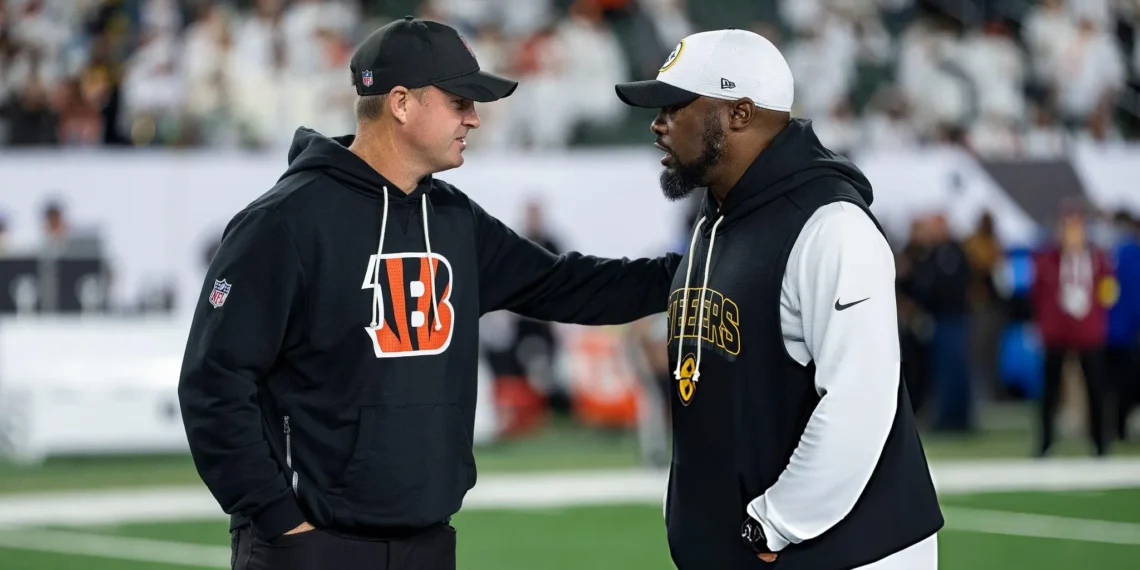 Head coach Zac Taylor of the Cincinnati Bengals and head coach Mike Tomlin of the Pittsburgh Steelers chat prior to an NFL football game at Paycor Stadium in Cincinnati, Ohio.