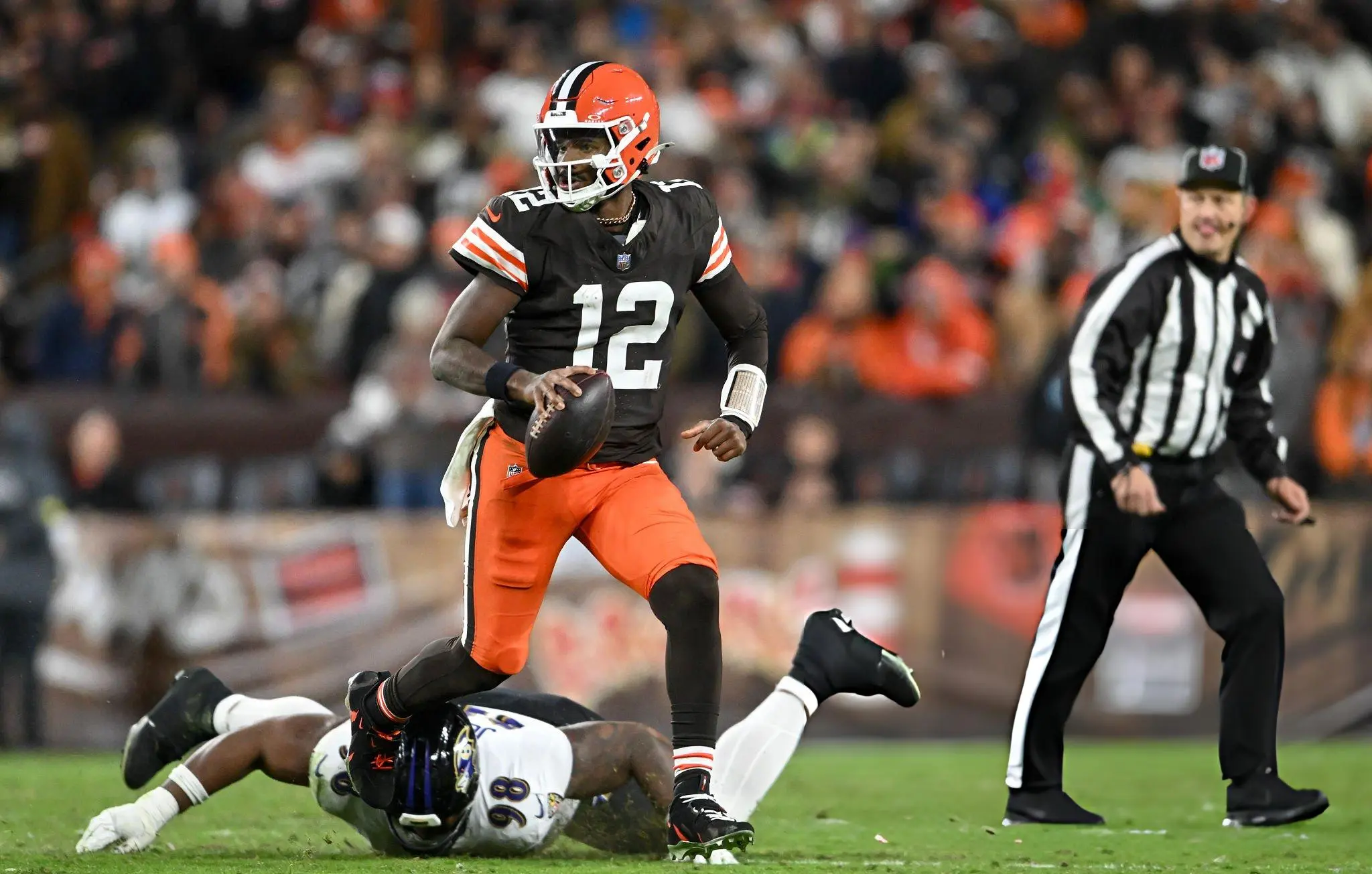 Shedeur Sanders #12 of the Cleveland Browns scrambles with the ball against the Baltimore Ravens during the fourth quarter at Huntington Bank Field on November 16, 2025 in Cleveland, Ohio.