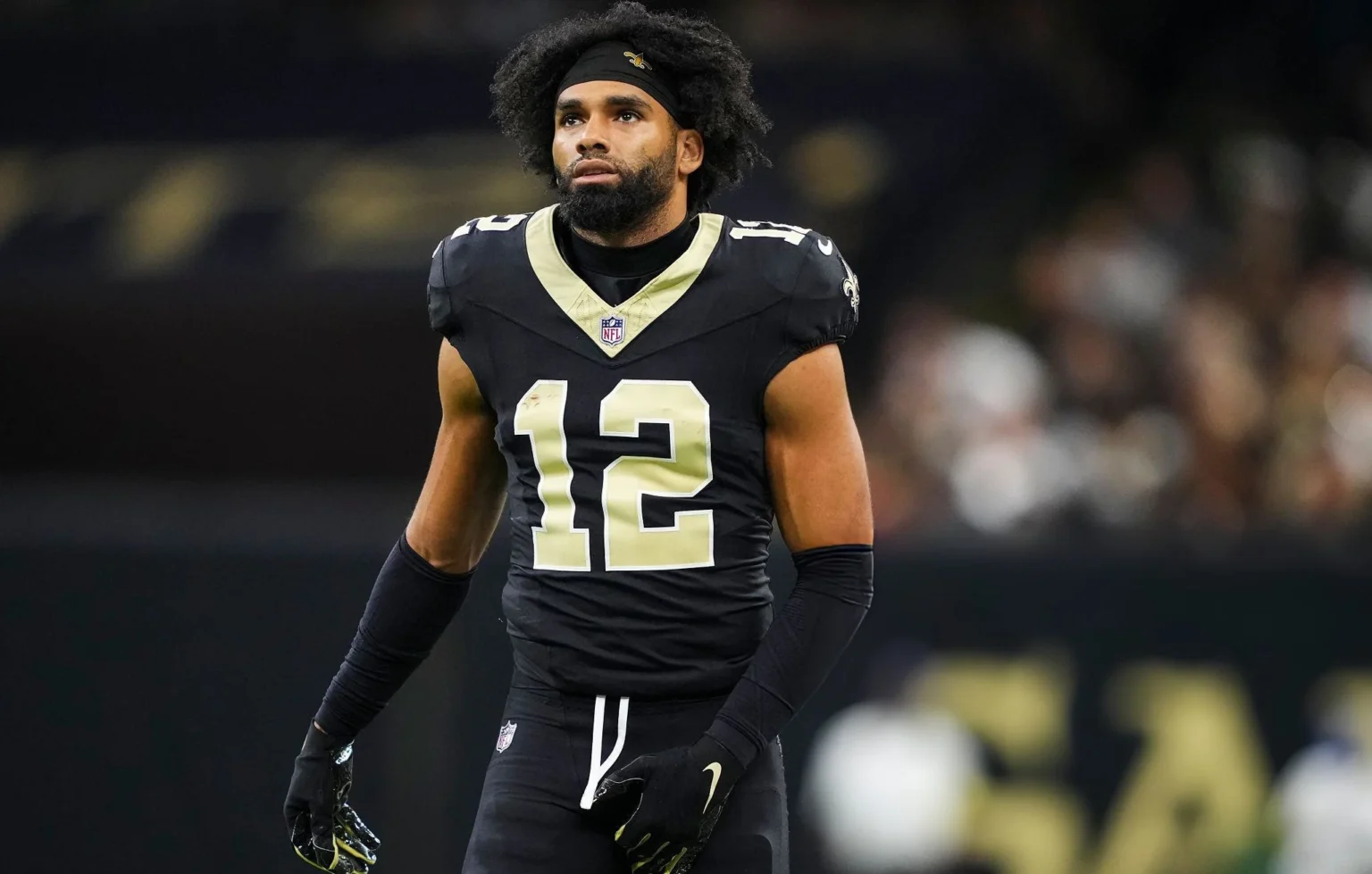 Chris Olave #12 of the New Orleans Saints looks on from the field during an NFL football game against the Atlanta Falcons at Caesars Superdome on November 23, 2025 in New Orleans, Louisiana. (Photo by Perry Knotts/Getty Images)