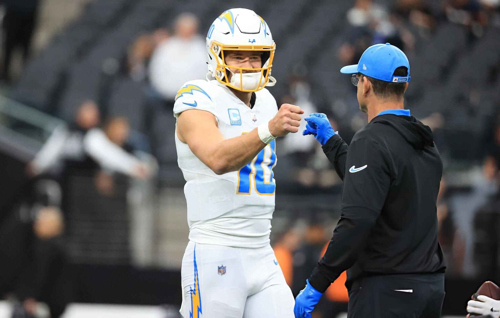 Justin Herbert #10 and head coach Jim Harbaugh of the Los Angeles Chargers