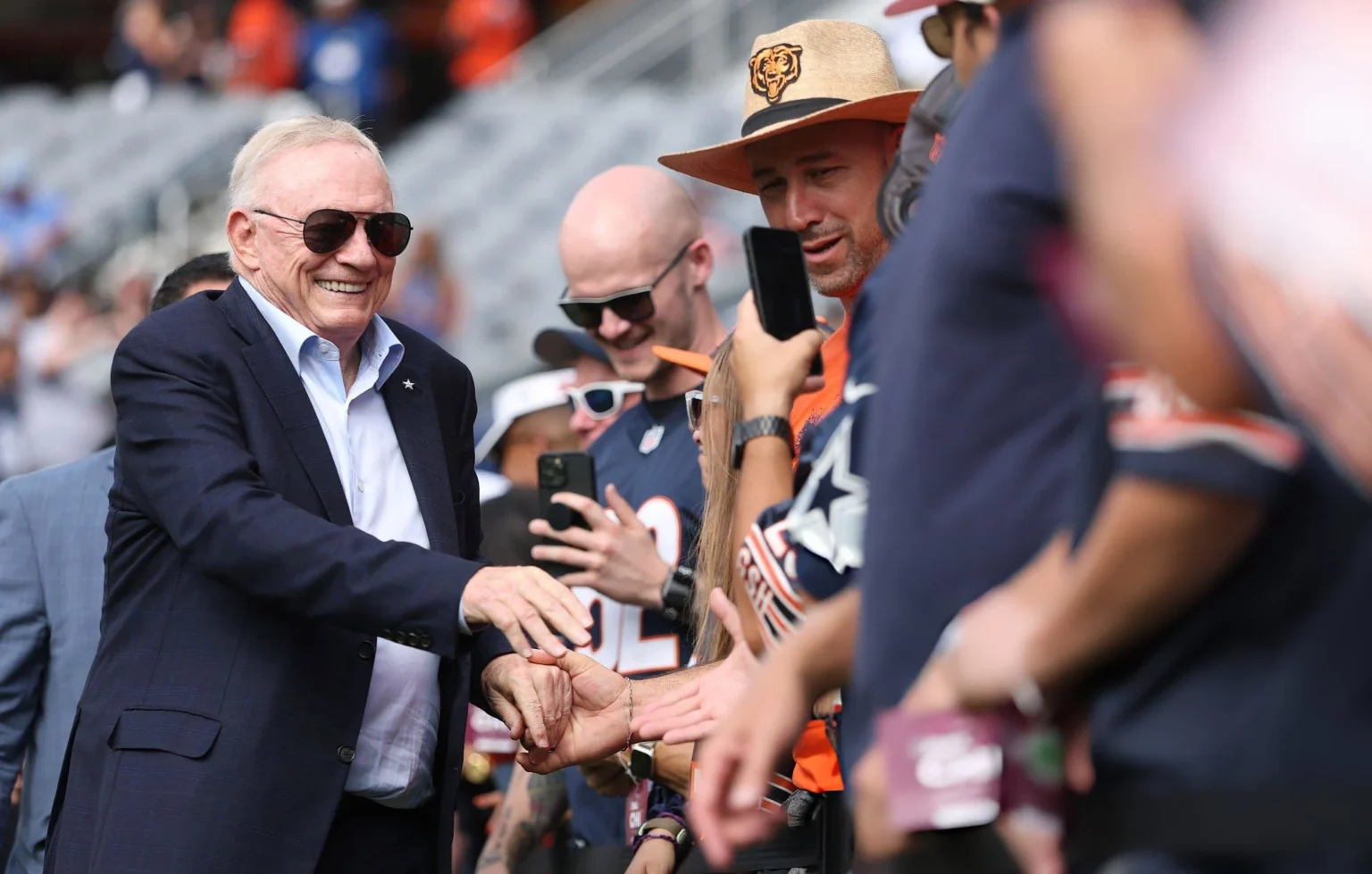 Dallas Cowboys Make a Powerful Community Move Reinforcing Their ‘America’s Team’ Status Owner Jerry Jones of the Dallas Cowboys shakes hand with fans before the game against the Chicago Bears at Soldier Field on September 21, 2025 in Chicago, Illinois.