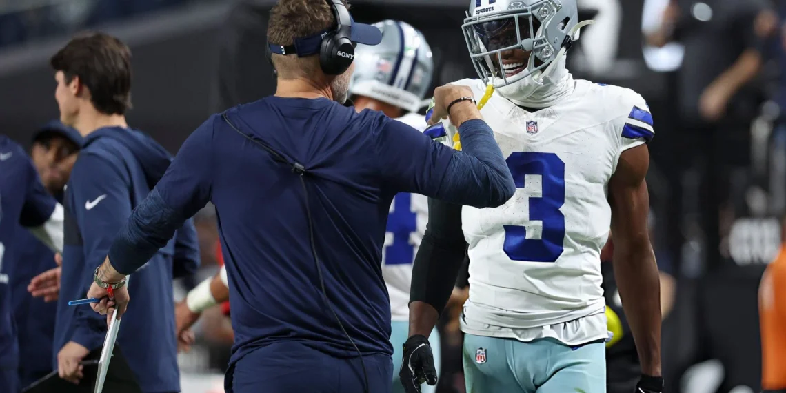 Brian Schottenheimer and George Pickens #3 of the Dallas Cowboys celebrate after their team's touchdown against the Las Vegas Raiders in the third quarter of a game at Allegiant Stadium