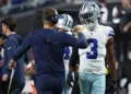 Brian Schottenheimer and George Pickens #3 of the Dallas Cowboys celebrate after their team's touchdown against the Las Vegas Raiders in the third quarter of a game at Allegiant Stadium