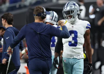 Brian Schottenheimer and George Pickens #3 of the Dallas Cowboys celebrate after their team's touchdown against the Las Vegas Raiders in the third quarter of a game at Allegiant Stadium
